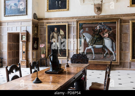 Spacious banqueting hall with table, chairs and artworks Stock Photo