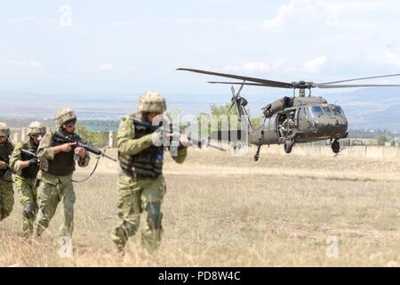 A Georgia Army National Guard UH-60 Black Hawk from the Marietta based, 1st Battalion, 171st Aviation Regiment, lifts off rapidly after inserting Georgian special forces during an urban operations exercise at the Vaziani Training Area on Aug 5, 2018 during Noble Partner 18, August 5, 2018. The exercise highlights the 24 years the two militaries have worked together under the U.S. National Guard's State Partnership Program. U.S Army photo by Staff Sgt. R. J. Lannom Jr. () Stock Photo