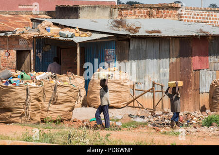 Children carry water back from a well in Mukono District, Uganda. Stock Photo