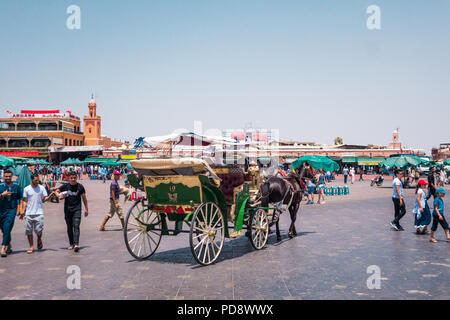 Marrakesh, Morocco - July 25th 2018 : view of horse-drawn carriage tour in Jemaa el Fna square Stock Photo