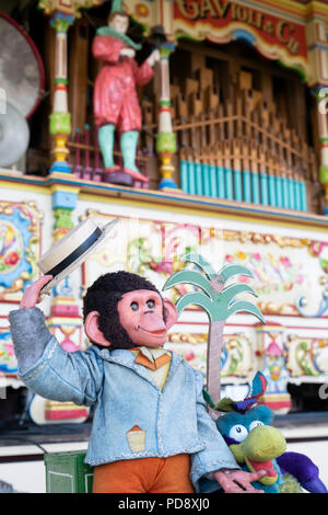 Mechanical monkey in front of a Steam Powered Victorian fairground organ at a steam fair in England. Stock Photo