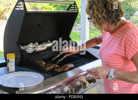 Grilling Steaks on the Patio Deck, USA Stock Photo