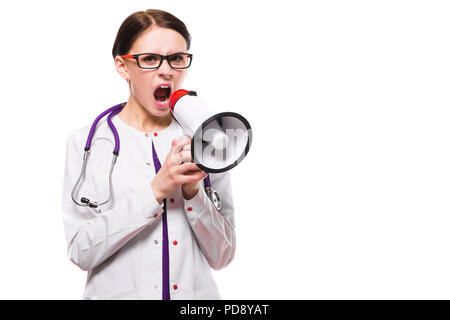 Young beautiful female doctor holding tablet in her hands speak in megaphone on white background Stock Photo