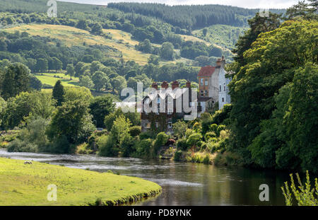 Housing overlooks The River Dee flowing through the Vale of Llangollen, Carrog, Denbighshire, North Wales, UK Stock Photo