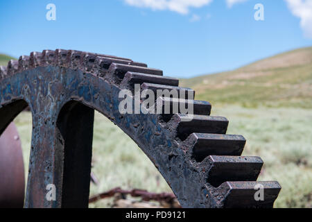 Close-up view of a vintage industrial rusted gear wheel in the ghost town of Bodie, California in the ghost town of Bodie, California Stock Photo