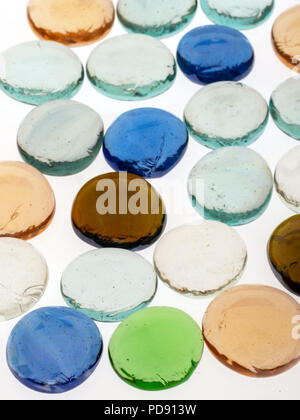 Abstract background from hand made glass pebbles of assorted colours on white. Stock Photo
