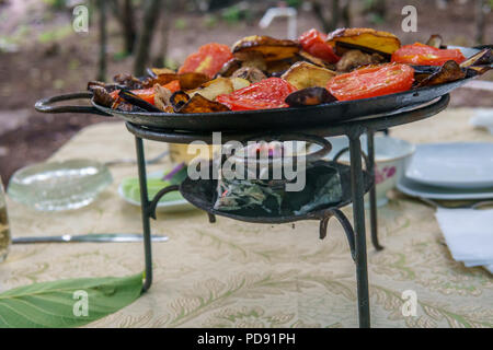 Saj kebap with mushrooms chicken. Outdoor picnic table. Stock Photo