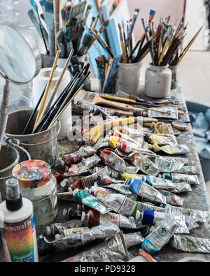 Paint brushes and oil paints in an artist's studio Stock Photo