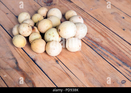 Lansium parasiticum, also known as langsat on the wooden table Stock Photo