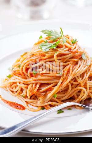Plate of pasta with homemade tomato sauce and parsley Stock Photo