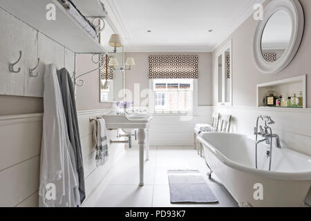 French-style basins and a free standing bath in master bathroom. The wall lights are from Vaughan and the blind is Jasper Michael smith fabric Stock Photo