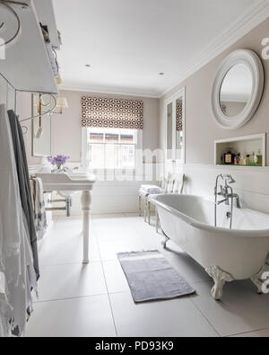 French-style basins and a free standing bath in master bathroom. The wall lights are from Vaughan and the blind is Jasper Michael smith fabric Stock Photo