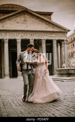 Young wedding couple by the Pantheon in Rome, Italy. Beautiful young