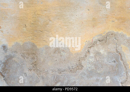 Textured grunge background. Old plastered wall with a multilayer cracked coating. Grunge texture with a deep pattern on yellow wall Stock Photo