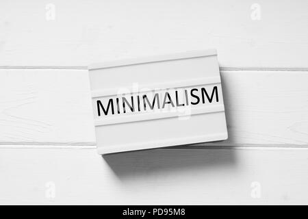 minimalism text on lightbox sign, minimal flat lay design on white wooden background, simplicity concept Stock Photo
