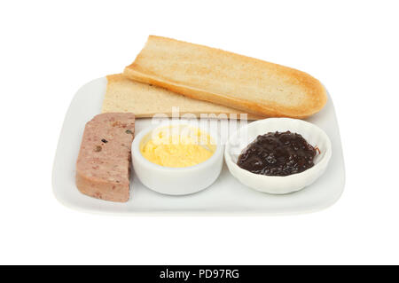 Farmhouse pate, toast, butter and onion marmalade on a plate isolated against white Stock Photo