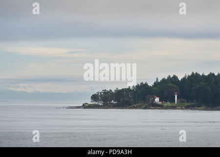 Georgina Point Lighthouse, Mayne Island, BC. Georgina Point Lighthouse on the shore of Mayne Island, BC, Canada. Stock Photo