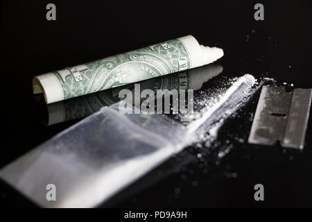 Man is about to snort cocaine with rolled up banknote. Narcotics ...