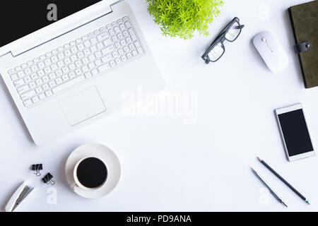 White desk office with laptop, smartphone and other work supplies with cup of coffee. Top view with copy space for input the text. Designer workspace  Stock Photo