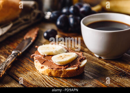 Breakfast with Banana Sandwich with Chocolate Spread, Coffee Cup and Grapes. Stock Photo