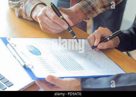 close up Business  colleagues discussing financial and graph analysis data on office table. Stock Photo