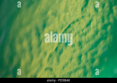 Close up of metal painted green reflecting yellow wheel of a tractor Stock Photo