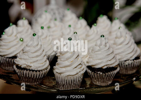 chocolate cupcakes with white cream on the tray, photo close-up Stock Photo