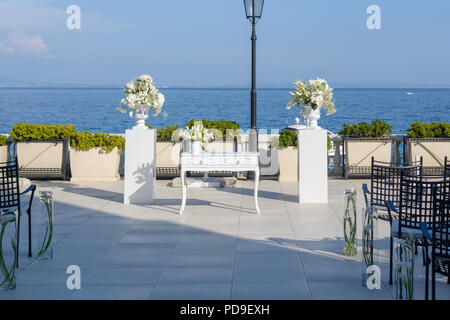 White table with white flower decoration prepared for wedding reception Stock Photo