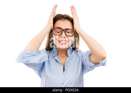 Young frustrated and upset woman in glasses squeezing head with hands unhappy with failure on white background Stock Photo