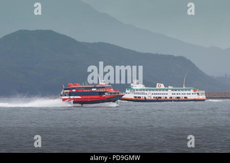 TurboJet Boeing JetFoil, TERCERIA, Enroute From Macau To Hong Kong, Passing Lantau Island And A First Ferry Passenger Ferry. Stock Photo