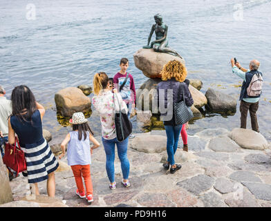 Copenhagen, Denmark -  July 7, 2017. Crowd of people around the Little Mermaid statue, an icon of the city and a popular tourist attraction. Based on  Stock Photo