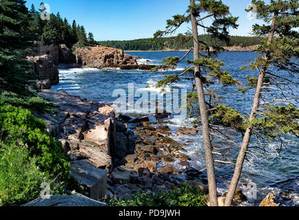 The coastline of Mount Desert Island, Maine located at Thunder Hole with a view of Sand Beach in the background. Stock Photo