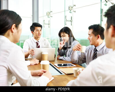 team of asian business men and women meeting in modern office. Stock Photo