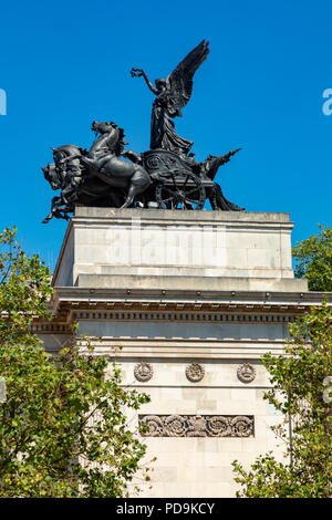 London England August 05, 2018 Statue of a Quadriga, an ancient four horsed chariot, on top of the Wellington Memorial Arch, at Hyde Park Corner Stock Photo