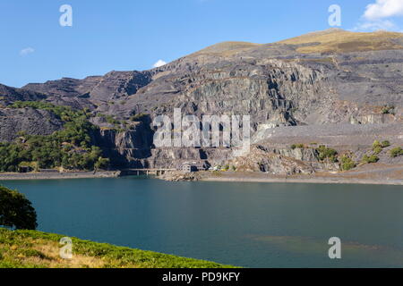 The huge Dinorwic slate quarry on the side of Elidir Fawr. Viewed across Llyn Peris the lower lake of Dinorwig pump storage power station. Stock Photo