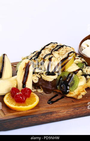 Waffle with chocolate sauce and banana, kiwi strawberry fruits Stock Photo