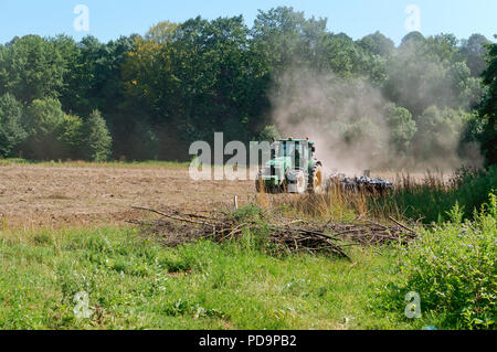 tractor plowing the land, agricultural machine working in the field Stock Photo