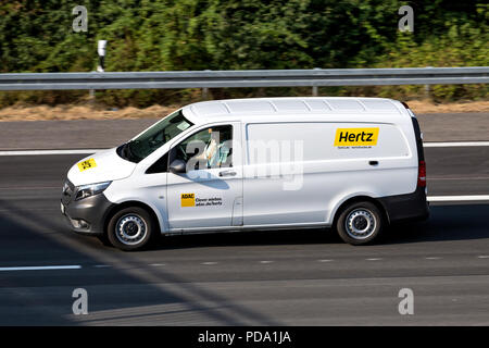 Mercedes-Benz Vito of Hertz on motorway. The Hertz Corporation is an American car rental company based in Estero, Florida. Stock Photo