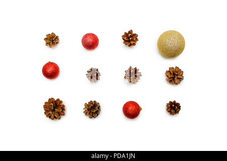 holidays, winter and celebration concept - Christmas composition. pine cones, red and golden balls on white background. Flat lay, top view. Stock Photo