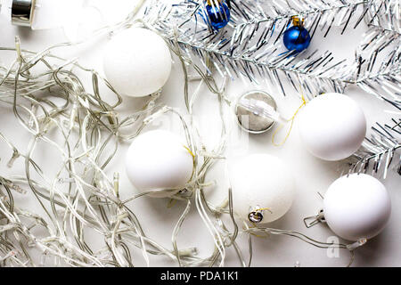 holidays, winter and celebration concept - Christmas composition. Preparations for decorating house and Christmas tree. garland, silver decorations, w Stock Photo