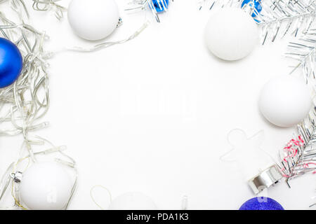 holidays, winter and celebration concept - Christmas frame made of silver fir branches, white balls, pine cones. Flat lay, top view, copy space Stock Photo