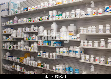 Medicines arranged on shelves at pharmacy Stock Photo