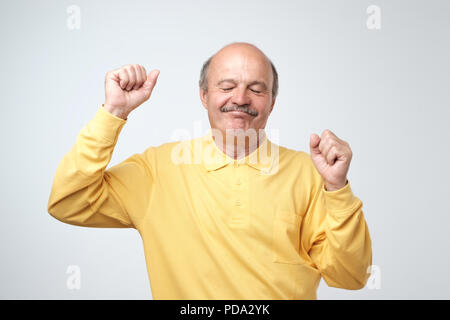 Mature happy man moving dancing over white background. Stock Photo