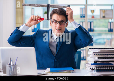 Stressed businessman thinking of suicide due to excessive workload Stock Photo