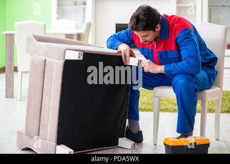 Repair contractor repairing broken furniture at home Stock Photo