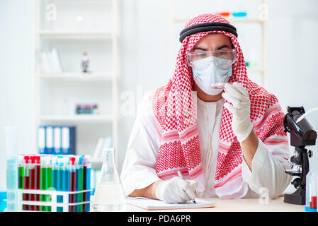 Arab doctor chemist studying new virus in lab Stock Photo