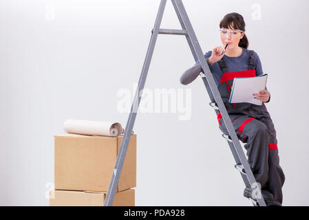 Woman builder thinking of renovating new apartment Stock Photo