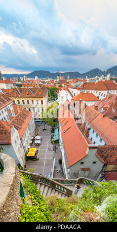 Vertical panorama of the historic city center of Graz. View from the Castle Hill on the city skyline during sunset. Stock Photo