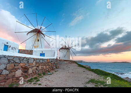 Traditional white windmills at sunrise, Mykonos, Greece Stock Photo