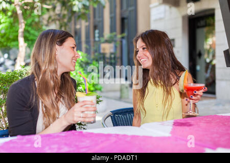 Portrait of two friends drinking a cocktail Stock Photo